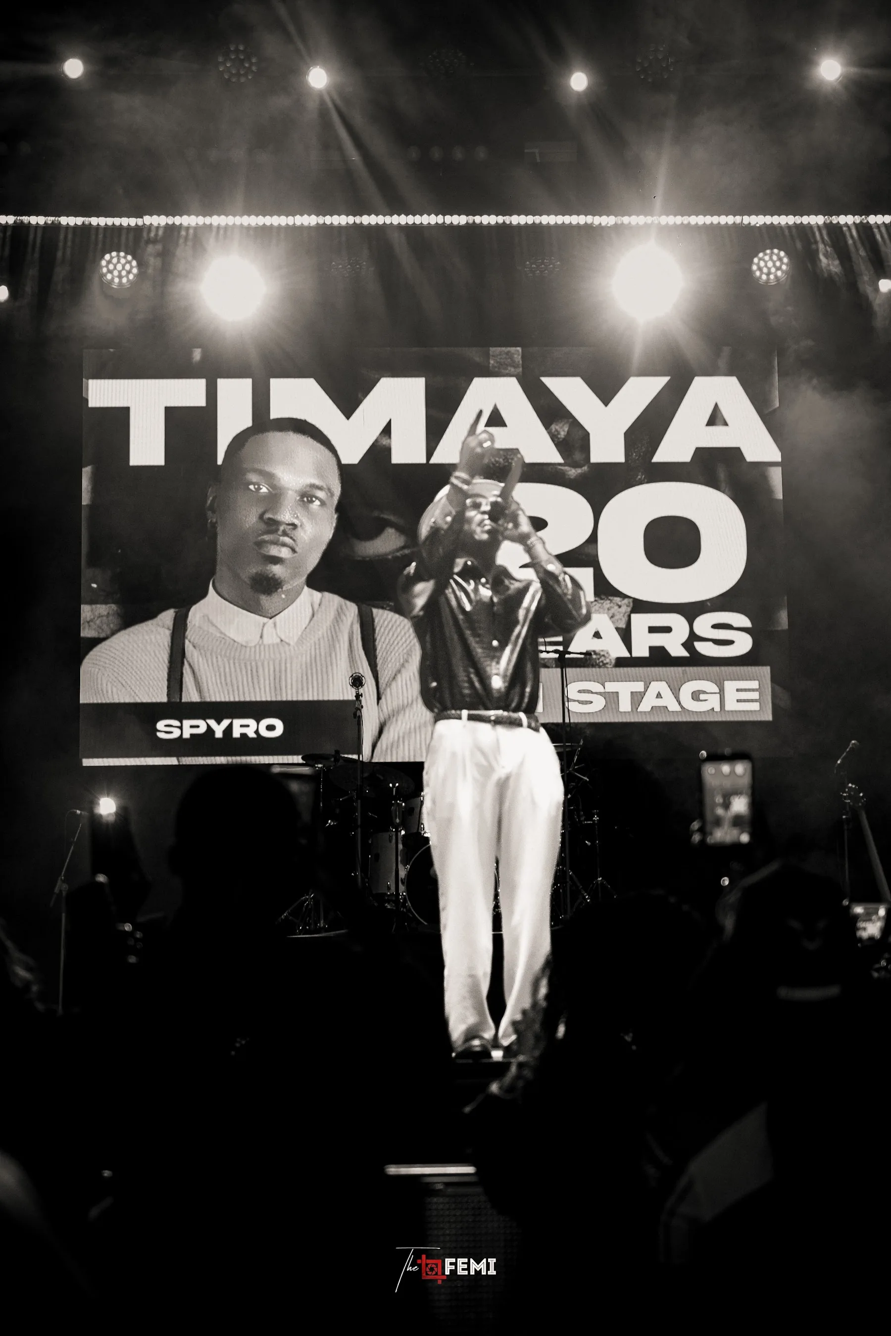 Timaya performing on stage in black and white