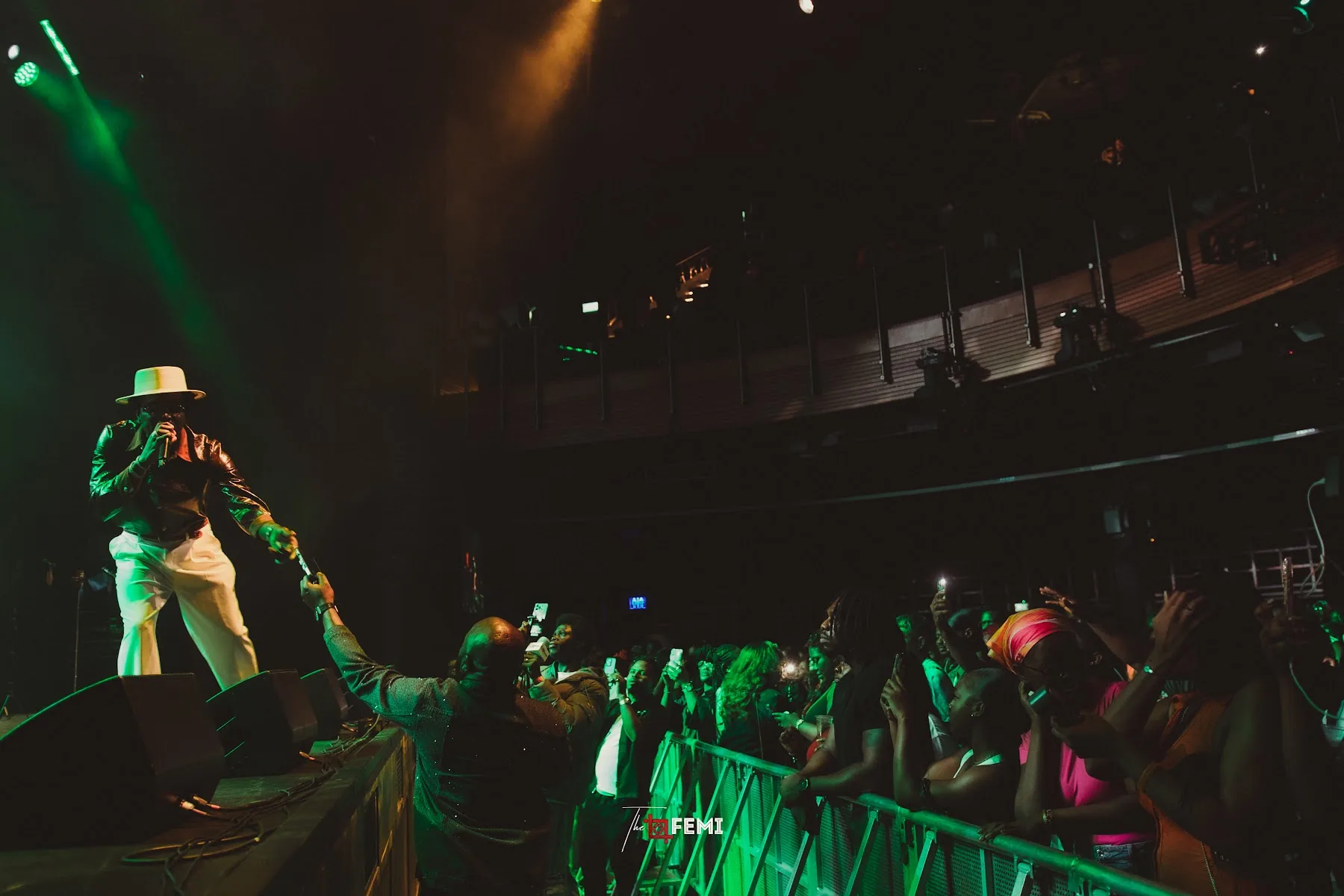 Fans at the barrier reaching towards the stage