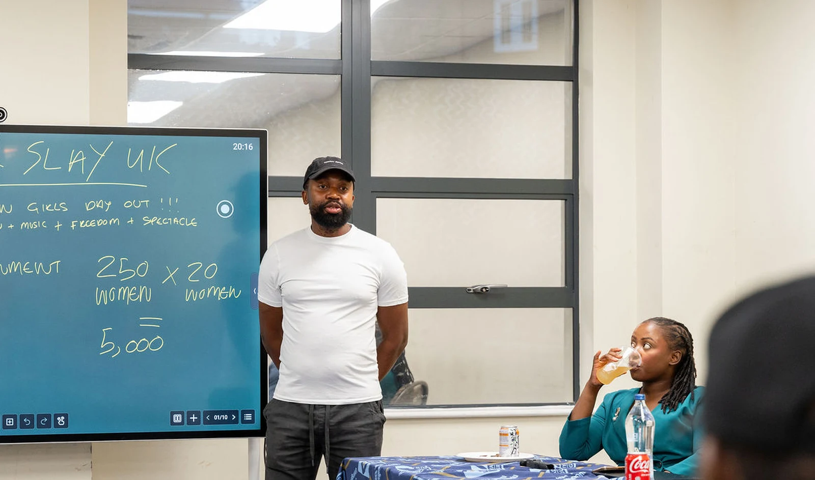 Korrine Sky and the room in front of the Doek & Slay strategy board at Nyaradzo House