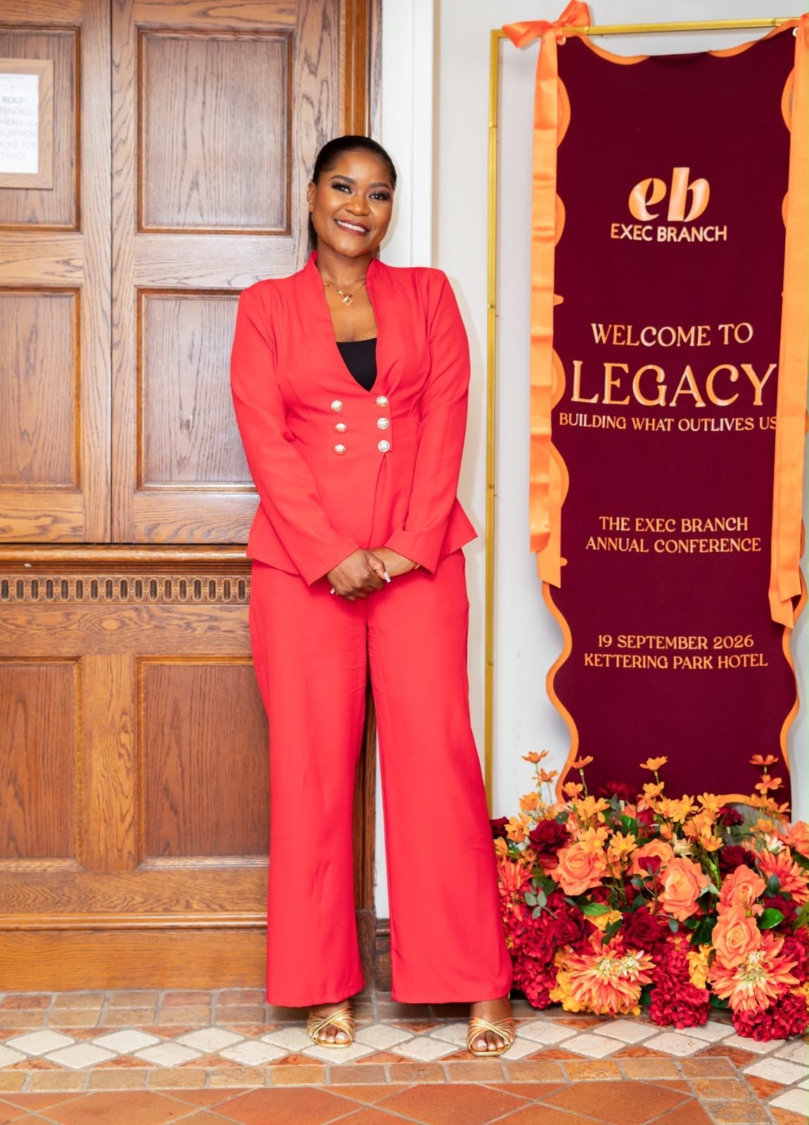 Korrine Sky at the LEGACY welcome banner, The Exec Branch Annual Conference