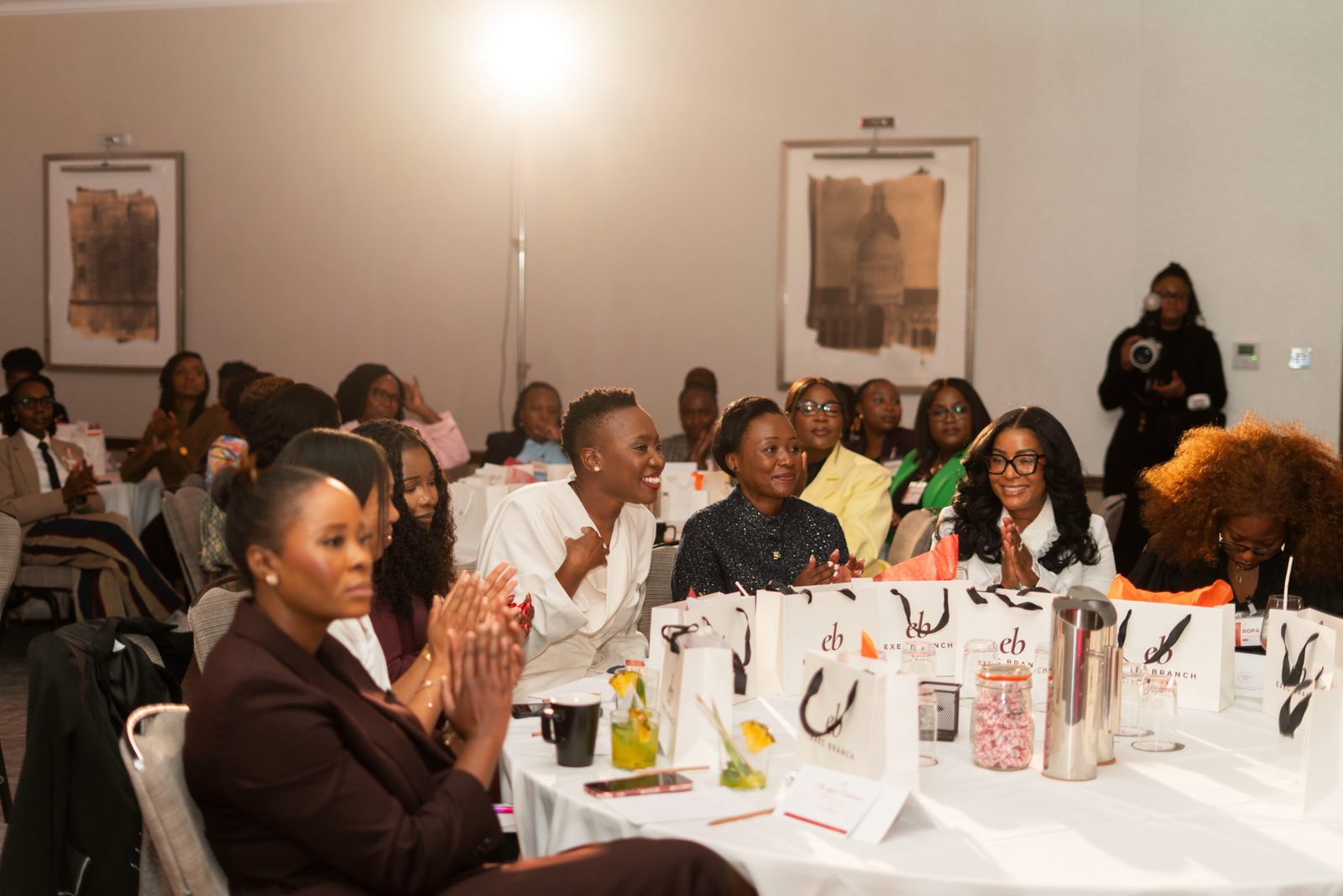 Delegates applauding around their tables at the LEGACY conference