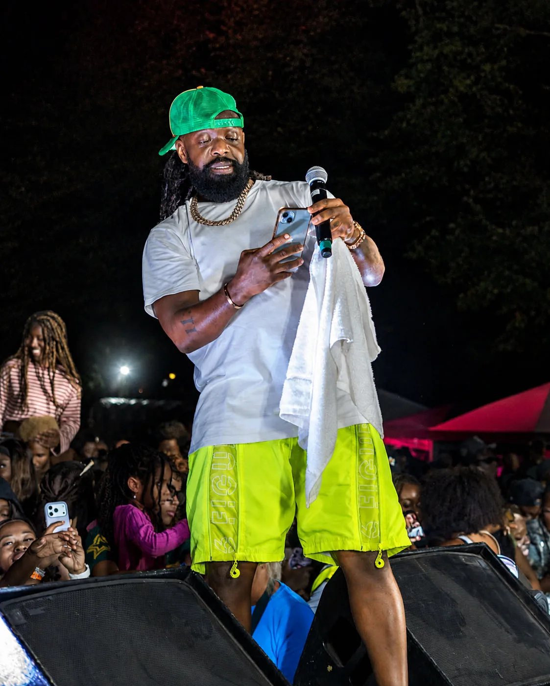 Timaya standing on the monitors above the front row