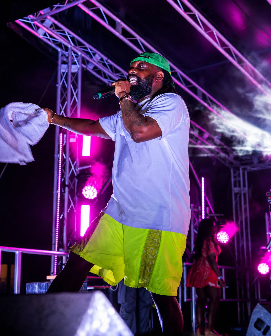 Timaya on stage with the lighting rig behind him