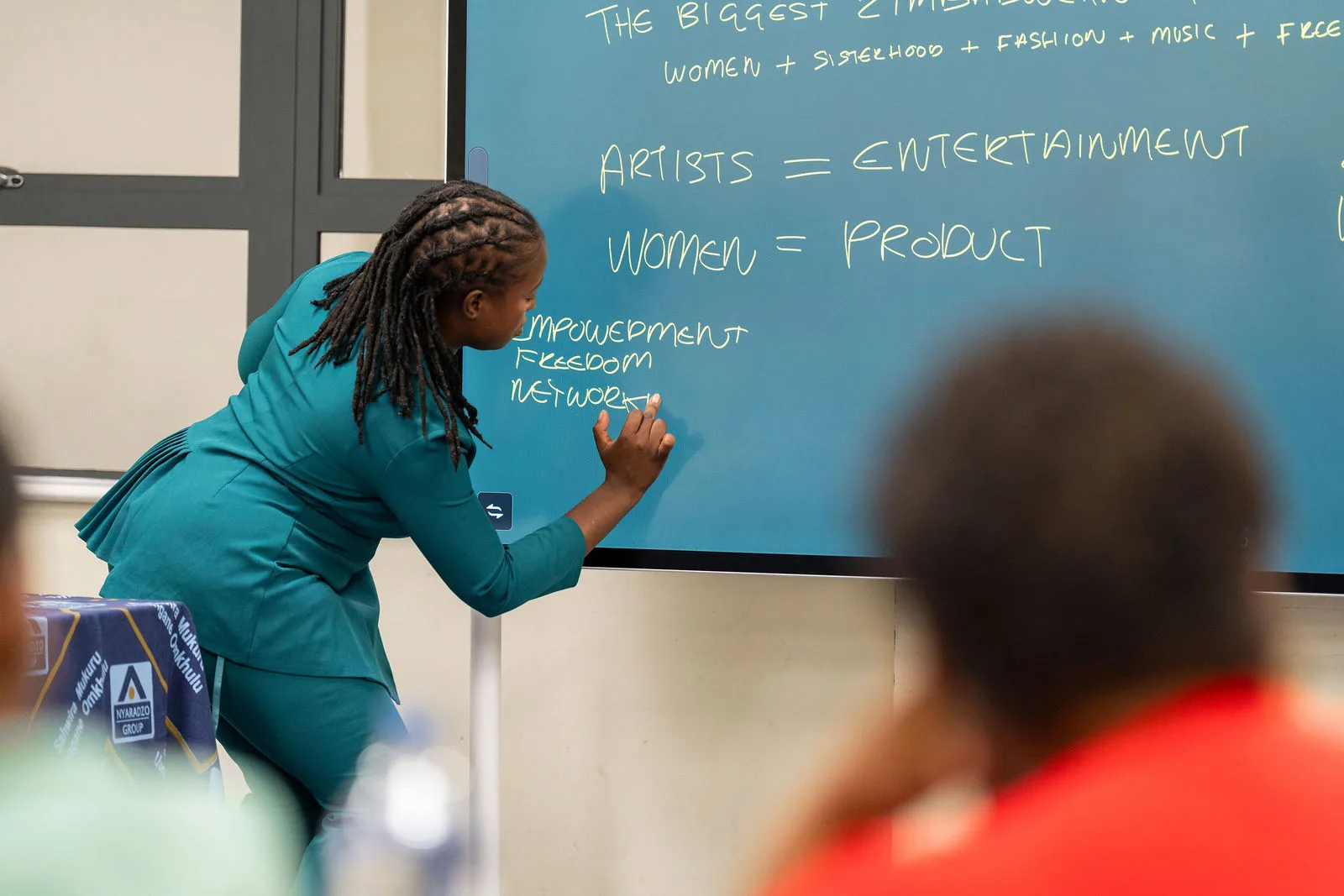 Korrine Sky writing the Doek & Slay audience strategy on the whiteboard