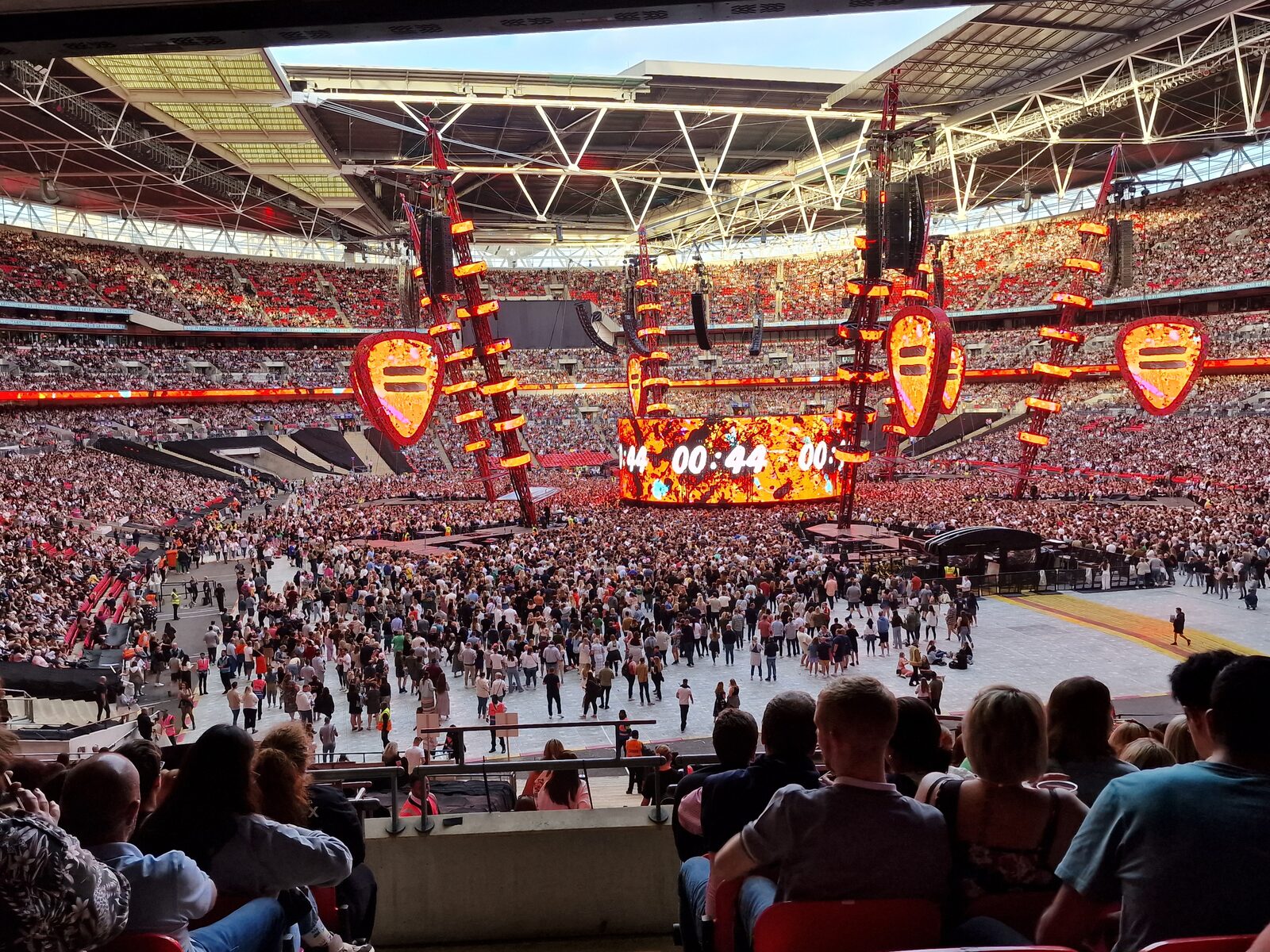A stadium crowd waiting for an Ed Sheeran performance at Wembley Stadium